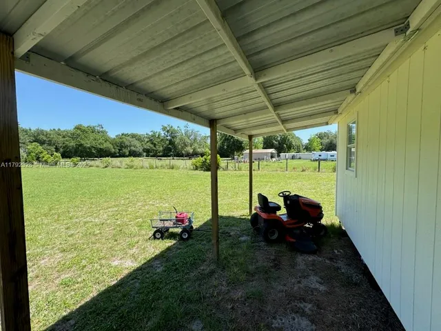 a view of a couches in patio of a yard