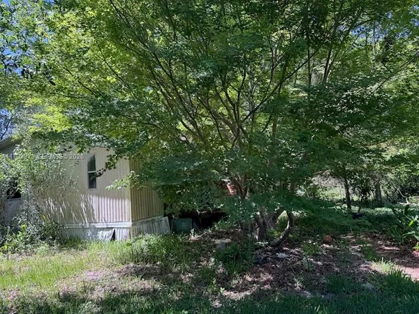 a backyard of a house with lots of green space and fountain