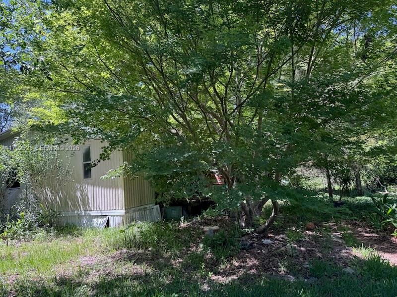 3725 Southwest 162nd Street Archer, FL 32618 - Photo 8 of 48 a backyard of a house with lots of green space and fountain