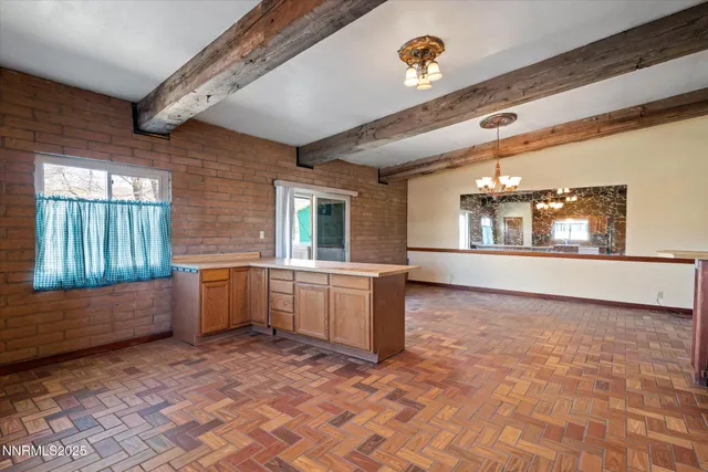 a large room with a window and chandelier