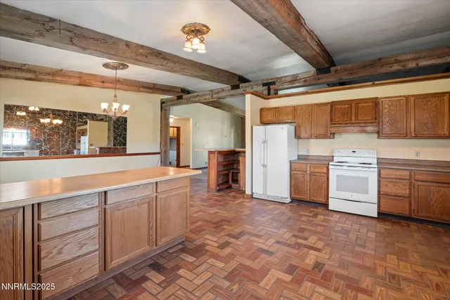 a large white kitchen with sink and cabinets