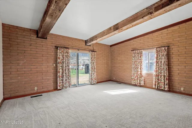 a view of an empty room with closet