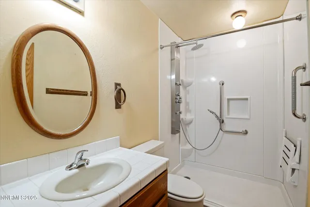 a bathroom with a sink toilet and a mirror