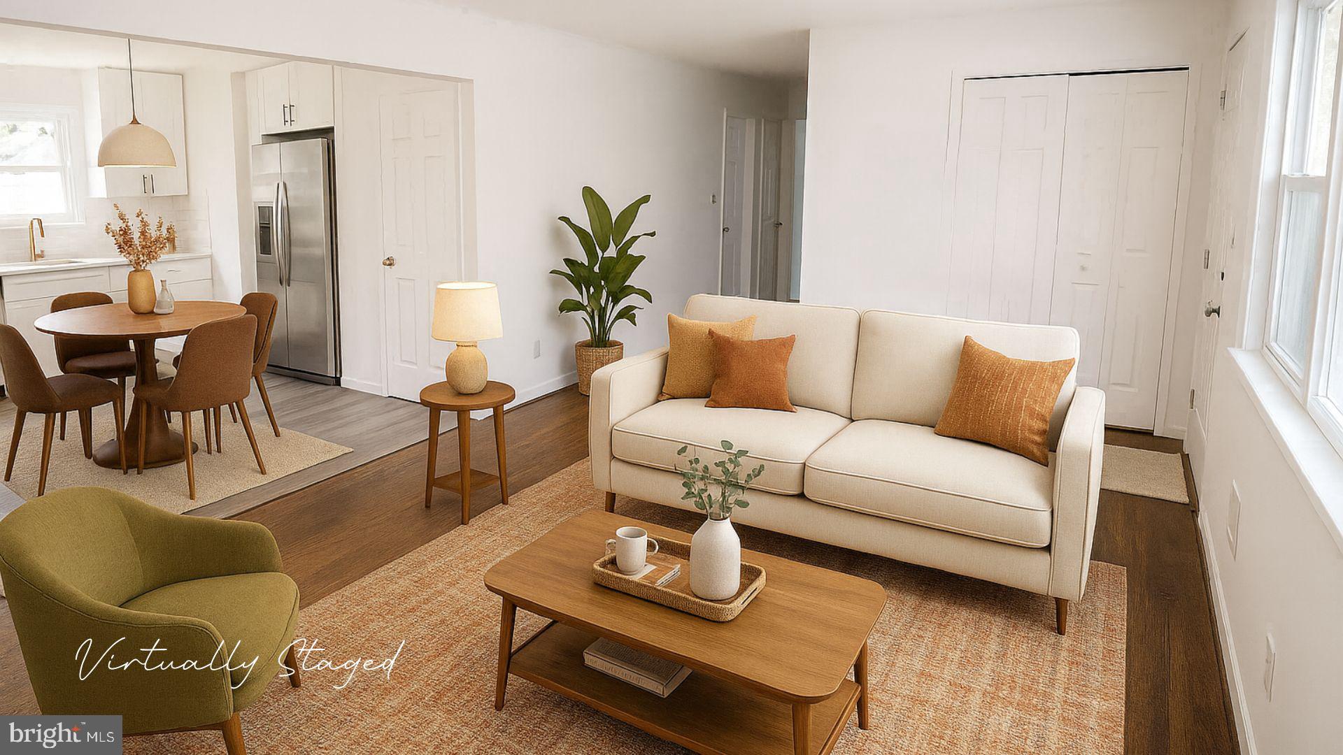 a living room with furniture and a potted plant