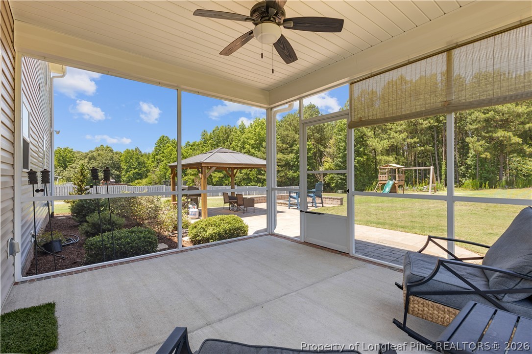 137 Minter School Road Sanford, NC 27332 - Photo 40 of 50 a view of a patio with a table and chairs under an umbrella
