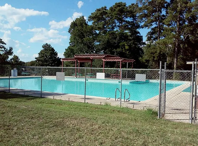 a view of a house with backyard and trees