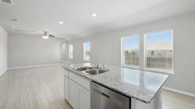 a kitchen with stainless steel appliances granite countertop a sink stove and cabinets