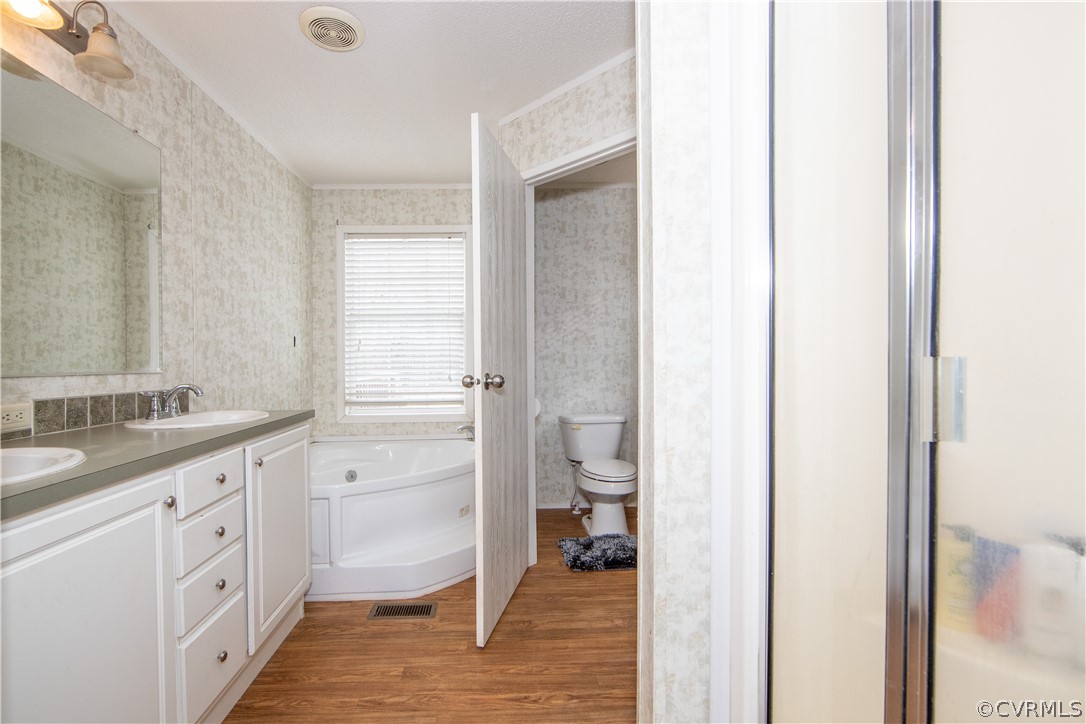 38 Bonbrook Creek Road Cumberland, VA 23040 - Photo 13 of 25 The beautiful primary bathroom has double vanity, garden tub, shower and separate water. closet.