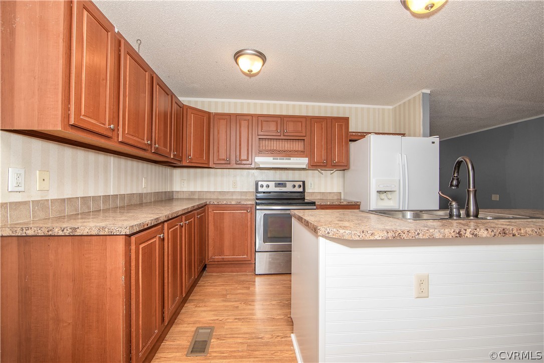 38 Bonbrook Creek Road Cumberland, VA 23040 - Photo 6 of 25 The kitchen boasts LVP flooring, laminate countertops and loads of cabinet space for storage.