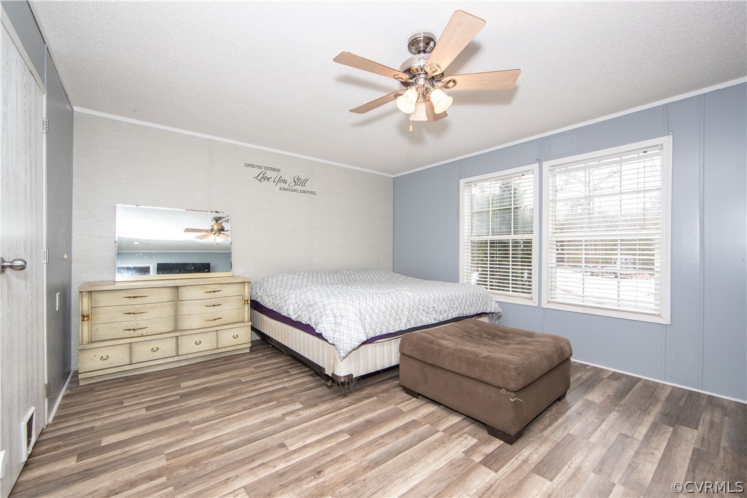 38 Bonbrook Creek Road Cumberland, VA 23040 - Photo 10 of 25 The primary bedroom boasts vinyl flooring, ceiling fan and a large closet.