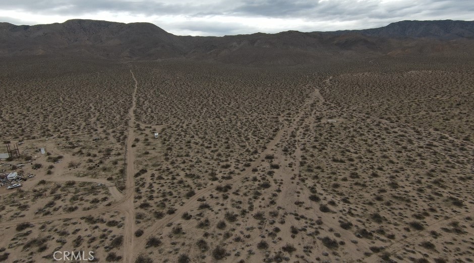 1234 1 Hole Spring Road Landers, CA 92285 - Photo 8 of 9 a view of a dry yard with mountains in the background