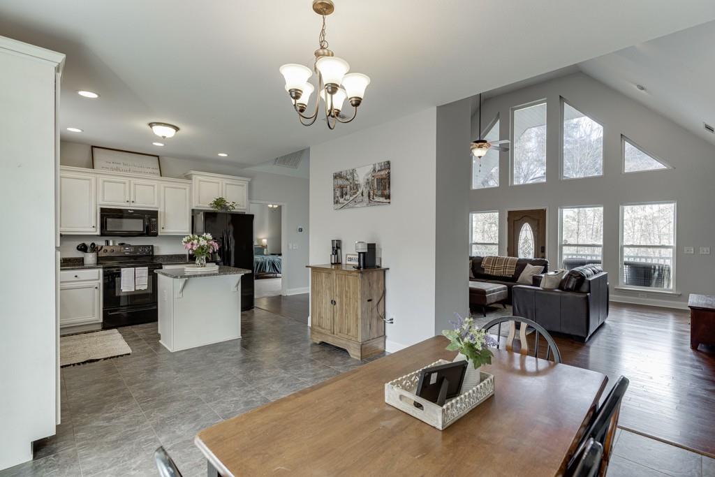 5050 Cagle Mill Road Lula, GA 30554 - Photo 11 of 48 a living room with furniture and a chandelier