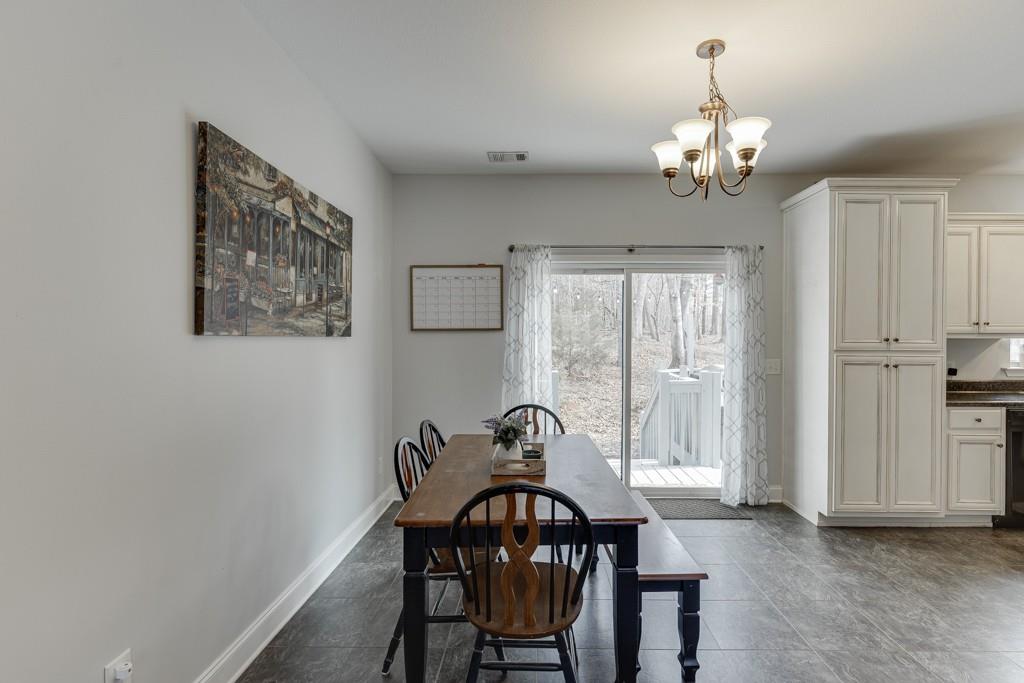 5050 Cagle Mill Road Lula, GA 30554 - Photo 12 of 48 a view of a dining room with furniture and chandelier