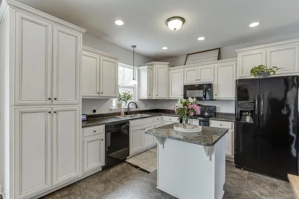 a kitchen with kitchen island sink stainless steel appliances and cabinets