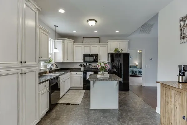 a kitchen with cabinets and appliances
