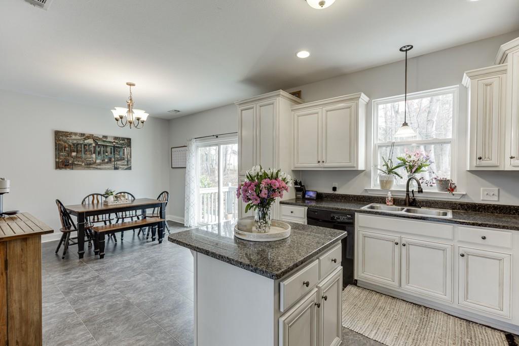 5050 Cagle Mill Road Lula, GA 30554 - Photo 17 of 48 a kitchen with granite countertop a sink stove and cabinets