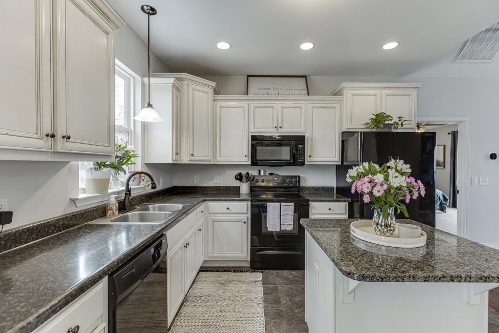 5050 Cagle Mill Road Lula, GA 30554 - Photo 19 of 48 a kitchen with stainless steel appliances granite countertop a sink a stove top oven a counter space and cabinets