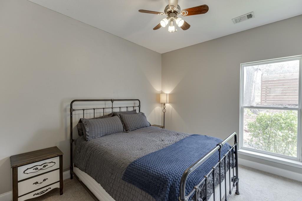 5050 Cagle Mill Road Lula, GA 30554 - Photo 20 of 48 a bedroom with a bed and a chandelier