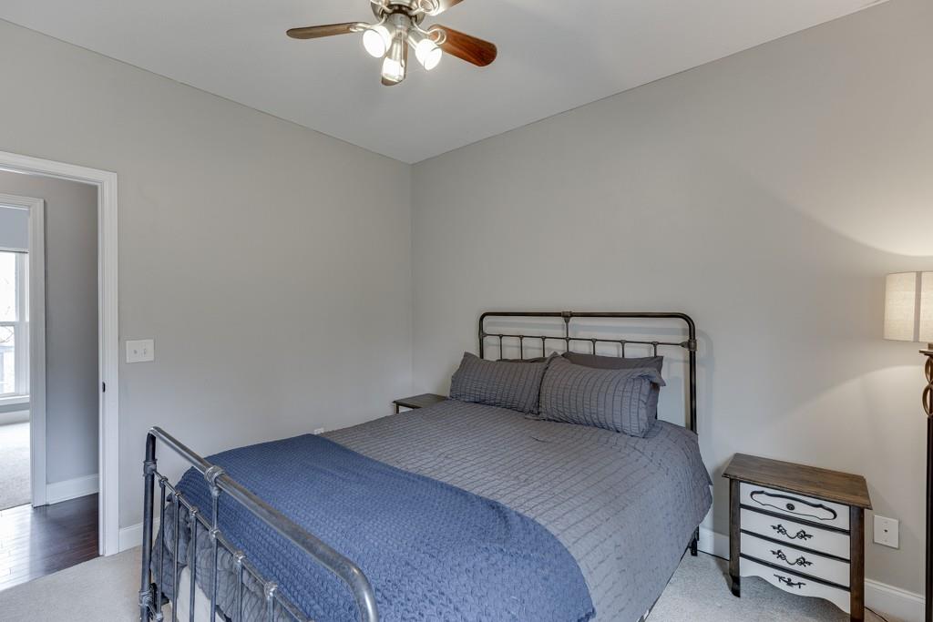 5050 Cagle Mill Road Lula, GA 30554 - Photo 21 of 48 a bedroom with a bed and a chandelier