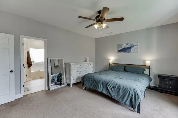 a bedroom with a large bed and a flat screen tv