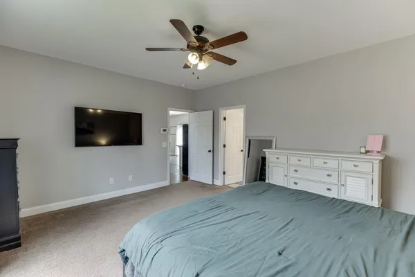 a bathroom with double vanity sink a mirror and a bathtub