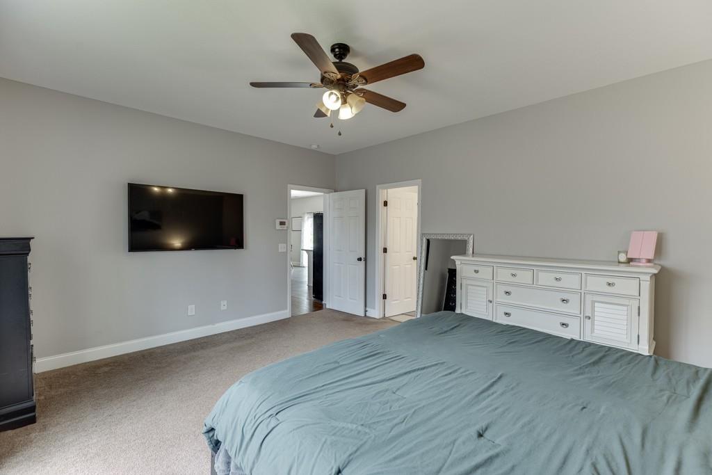 5050 Cagle Mill Road Lula, GA 30554 - Photo 30 of 48 a bedroom with a bed and a flat screen tv