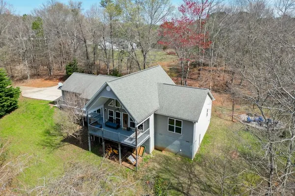 a view of a house with a yard and sitting area
