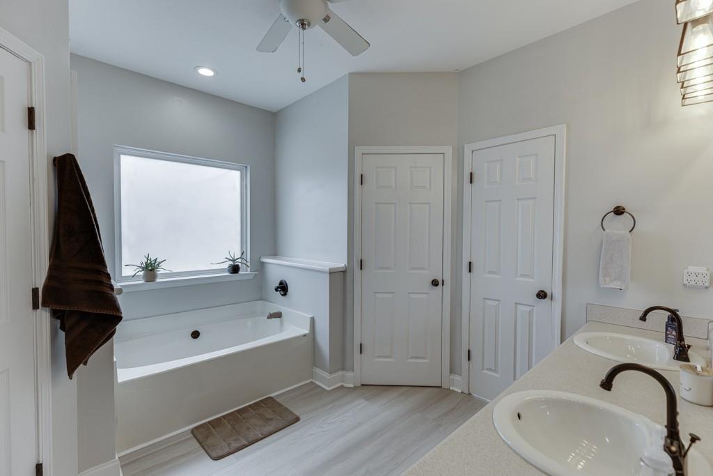 5050 Cagle Mill Road Lula, GA 30554 - Photo 34 of 48 a bathroom with a bathtub and a sink