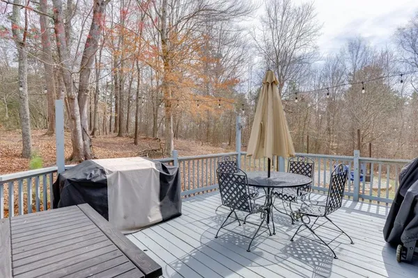 a view of balcony with wooden floor and fence