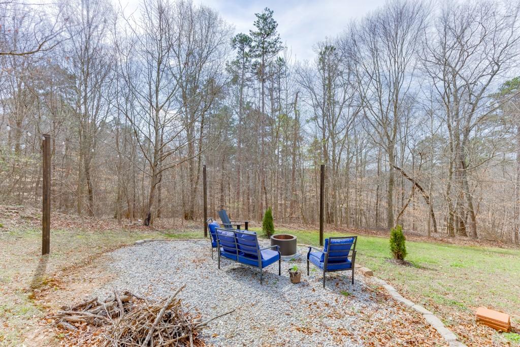 5050 Cagle Mill Road Lula, GA 30554 - Photo 42 of 48 a view of a sitting area with furniture and wooden fence