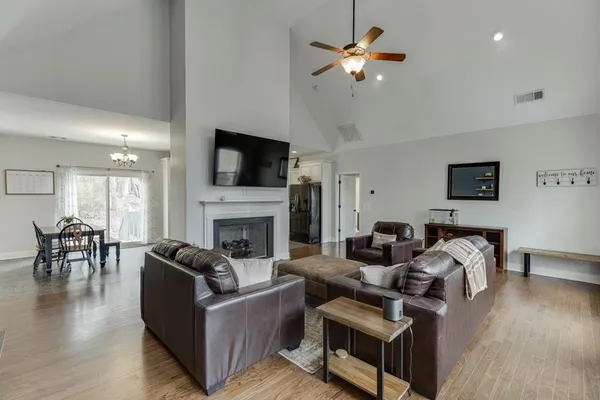 a living room with furniture a fireplace and a flat screen tv