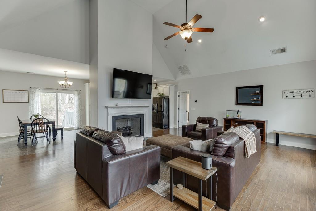 5050 Cagle Mill Road Lula, GA 30554 - Photo 6 of 48 a living room with furniture fireplace and a flat screen tv