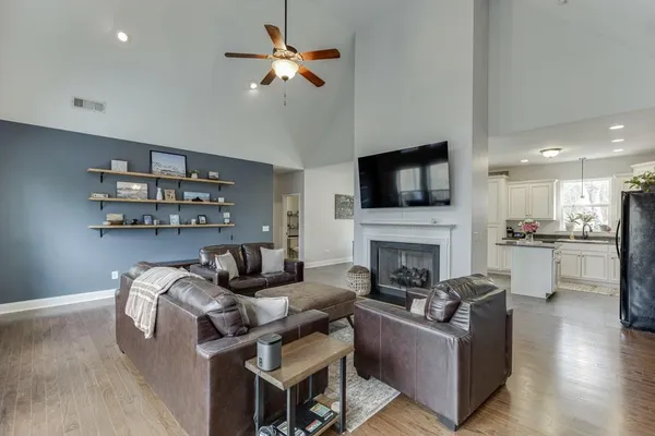 a living room with furniture wooden floor and a chandelier