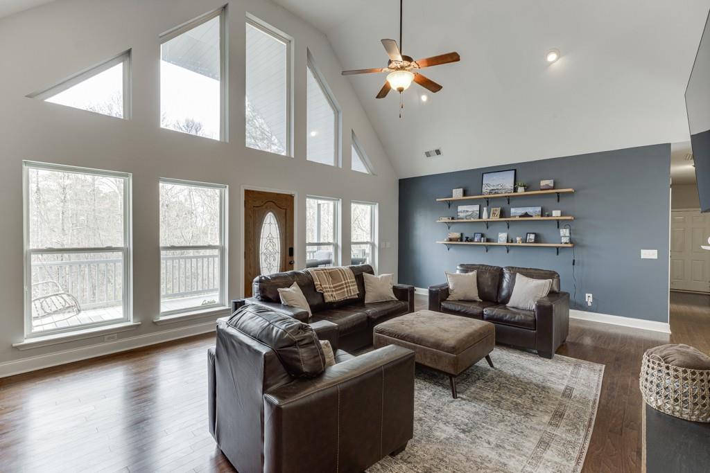 5050 Cagle Mill Road Lula, GA 30554 - Photo 8 of 48 a living room with furniture wooden floor and a chandelier