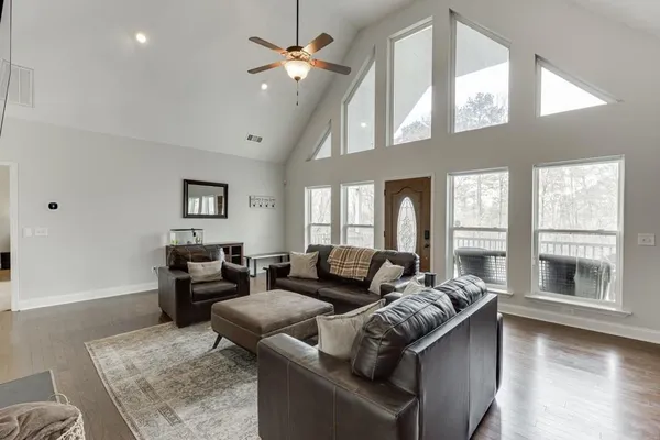 a kitchen with granite countertop a table chairs stove and refrigerator
