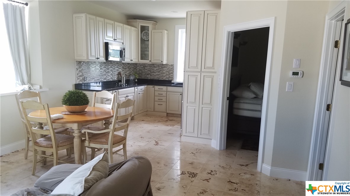 a dining room with furniture and a window