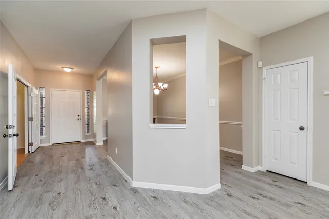 a view of a hallway with wooden floor