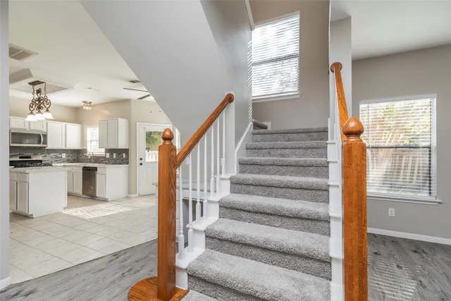 a view of kitchen with sink microwave and cabinets