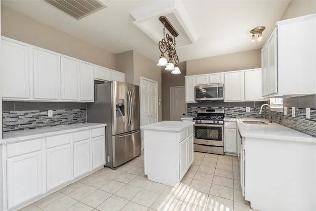a kitchen with a stove and a microwave