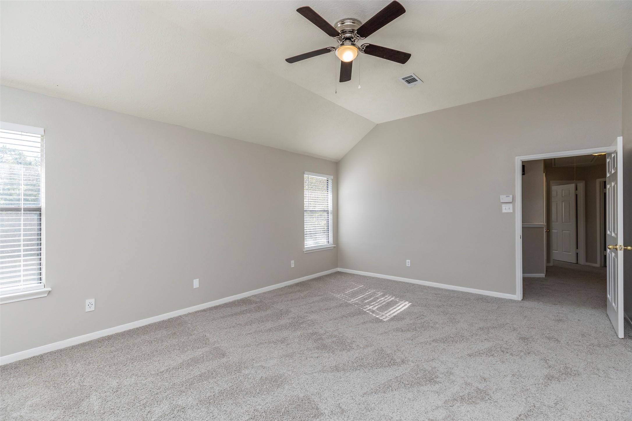 13110 Mills River Street Houston, TX 77070 - Photo 23 of 39 an empty room with windows and fan