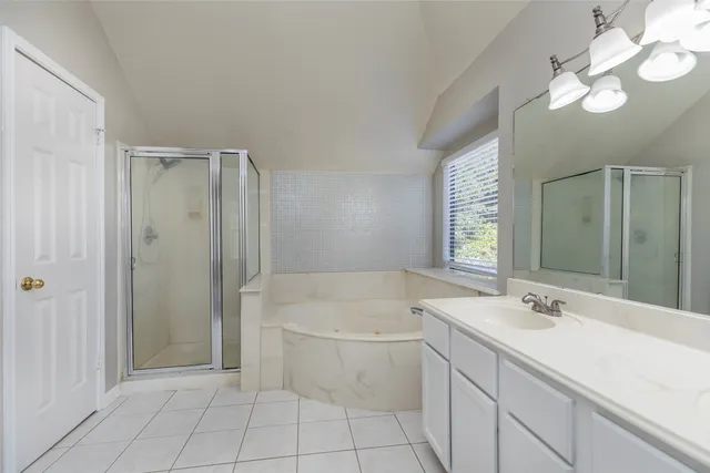 a bathroom with a sink a light fixture and a mirror