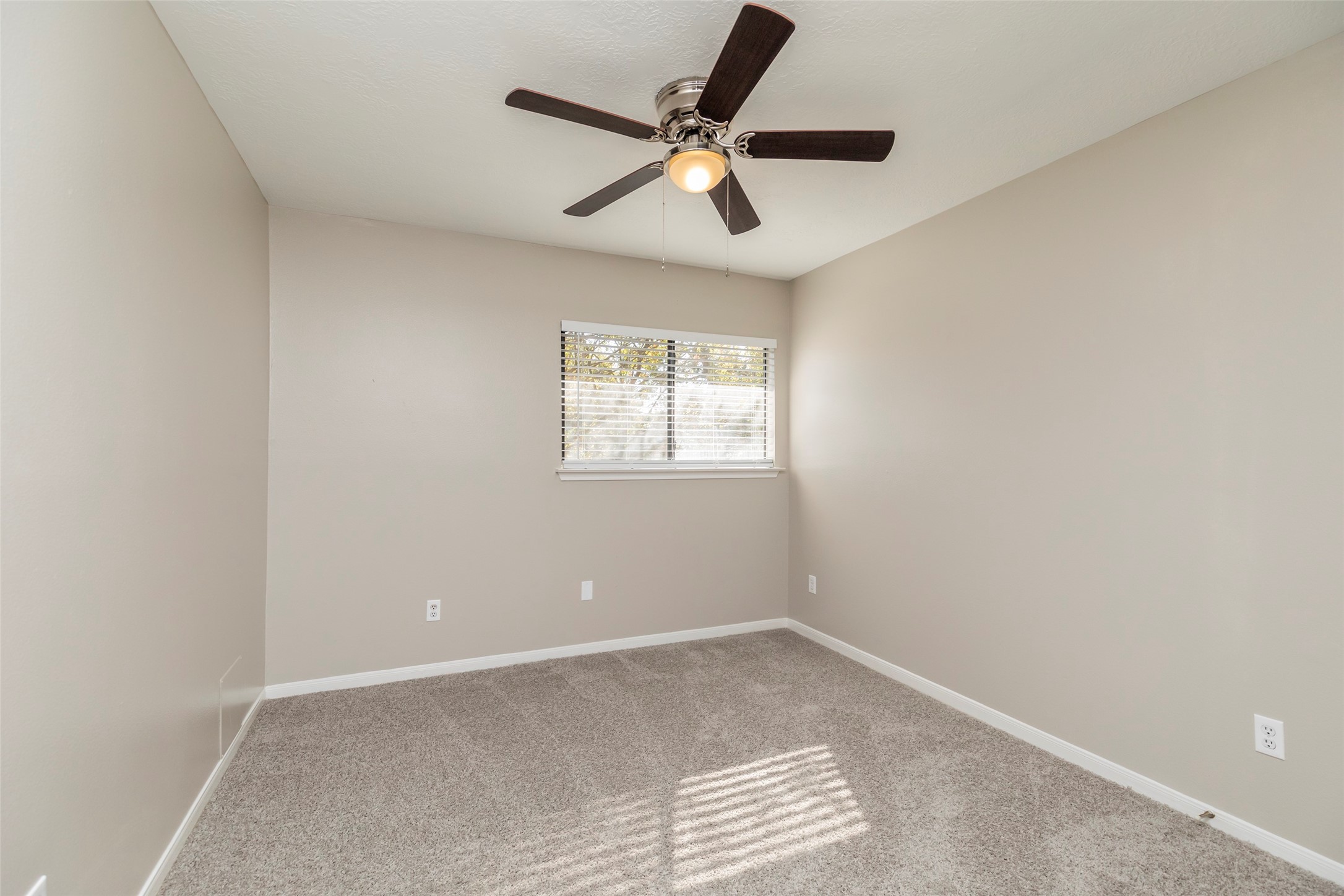13110 Mills River Street Houston, TX 77070 - Photo 35 of 39 an empty room with a window and a ceiling fan