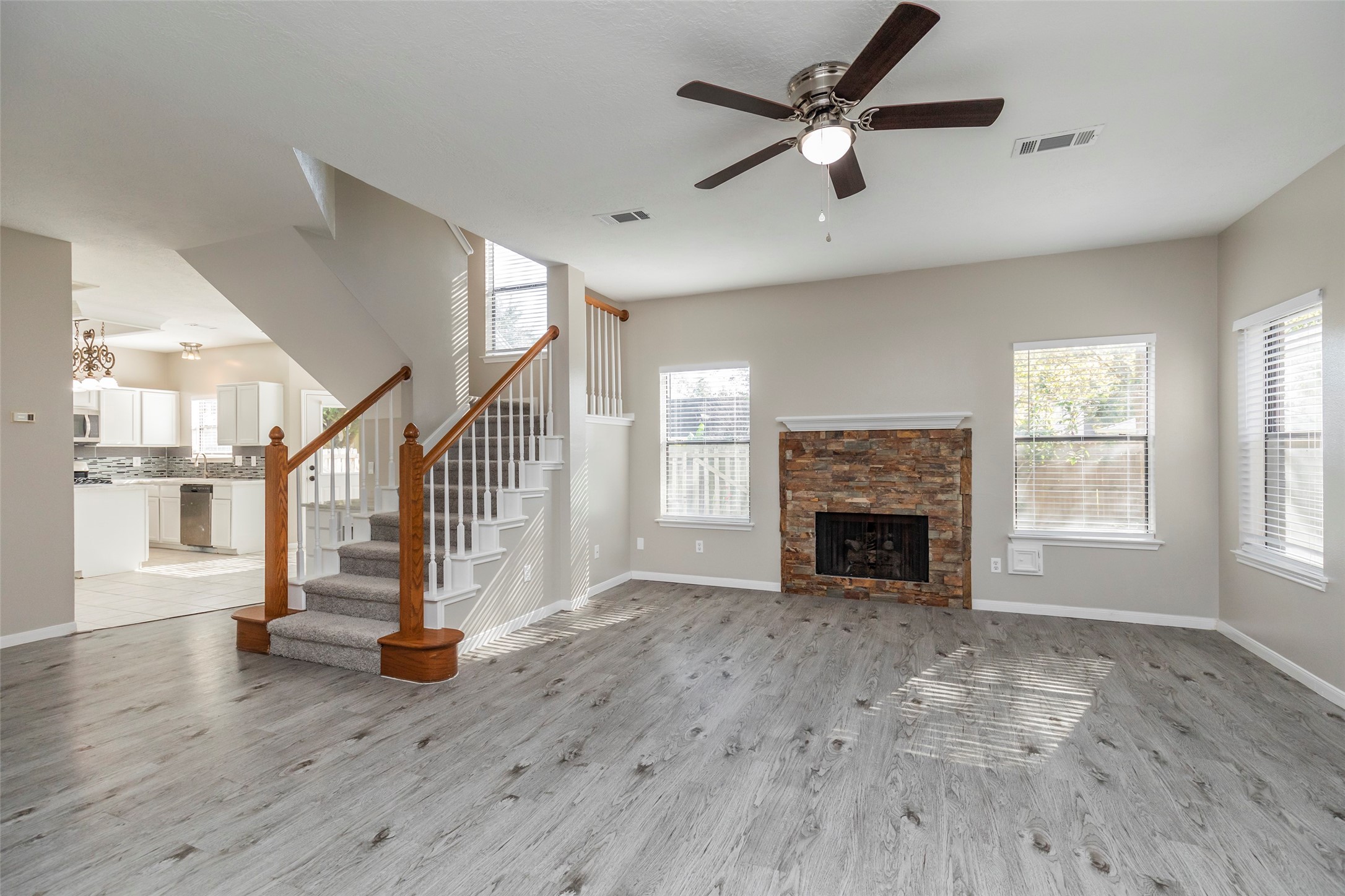 13110 Mills River Street Houston, TX 77070 - Photo 6 of 39 a view of empty room with fireplace and wooden floor