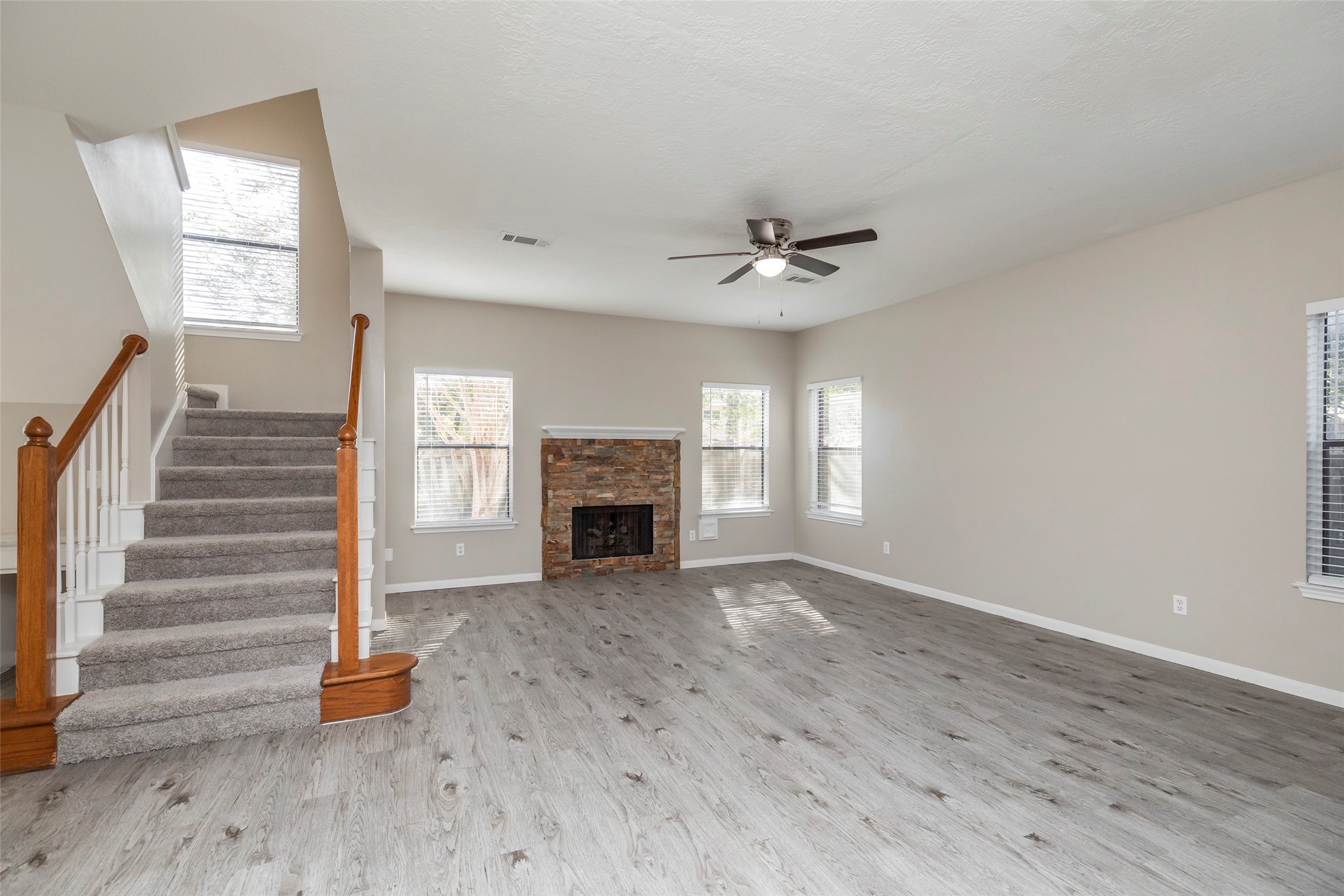 13110 Mills River Street Houston, TX 77070 - Photo 8 of 39 a view of an empty room with wooden floor and a window