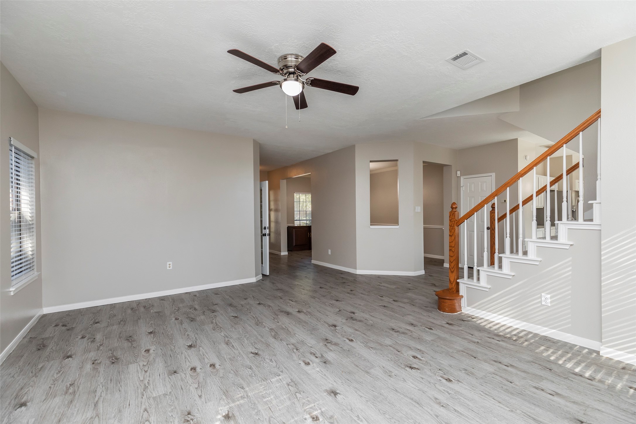 13110 Mills River Street Houston, TX 77070 - Photo 9 of 39 a view of an empty room with wooden floor and a window