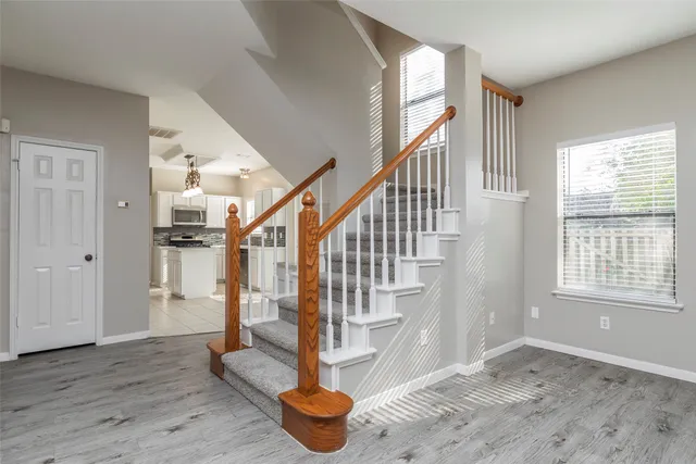 a view of entryway and hall with wooden floor