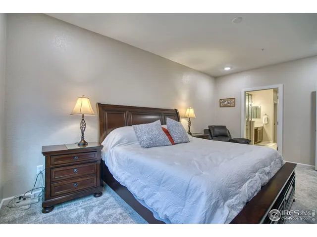 a bedroom with a bed and a lamp