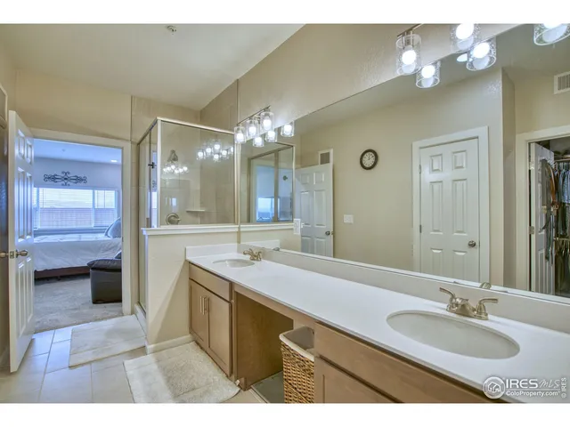 a bathroom with a granite countertop sink a large mirror and a bathtub