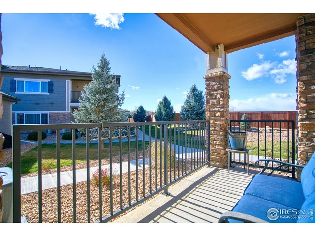 a view of a balcony with floor to ceiling windows wooden floor