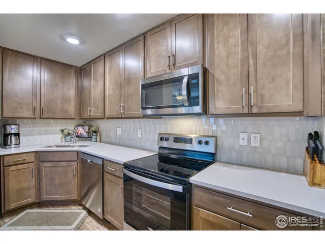 a kitchen with cabinets a sink and appliances